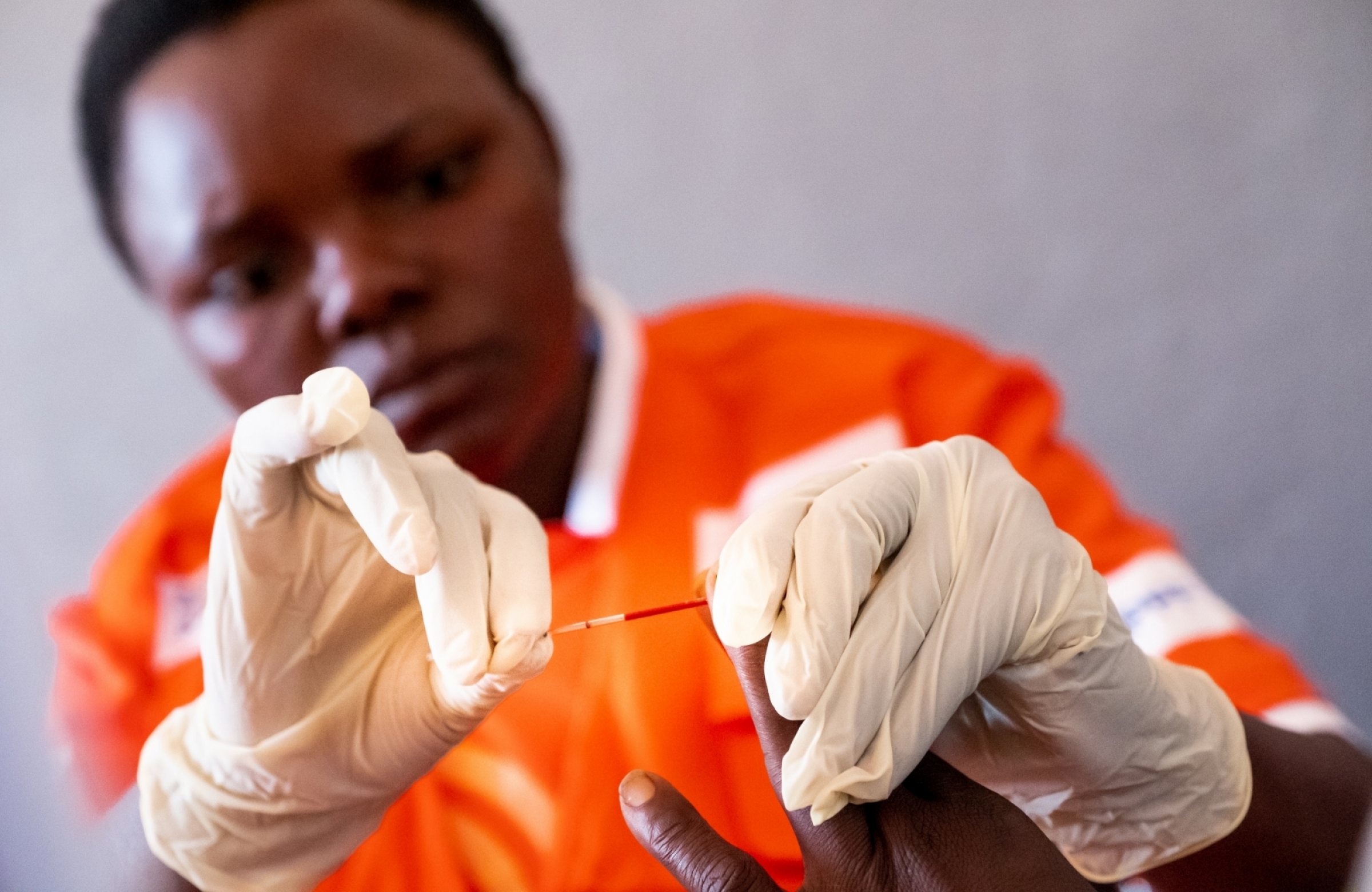 Nurse takes a blood prick from someone's finger.