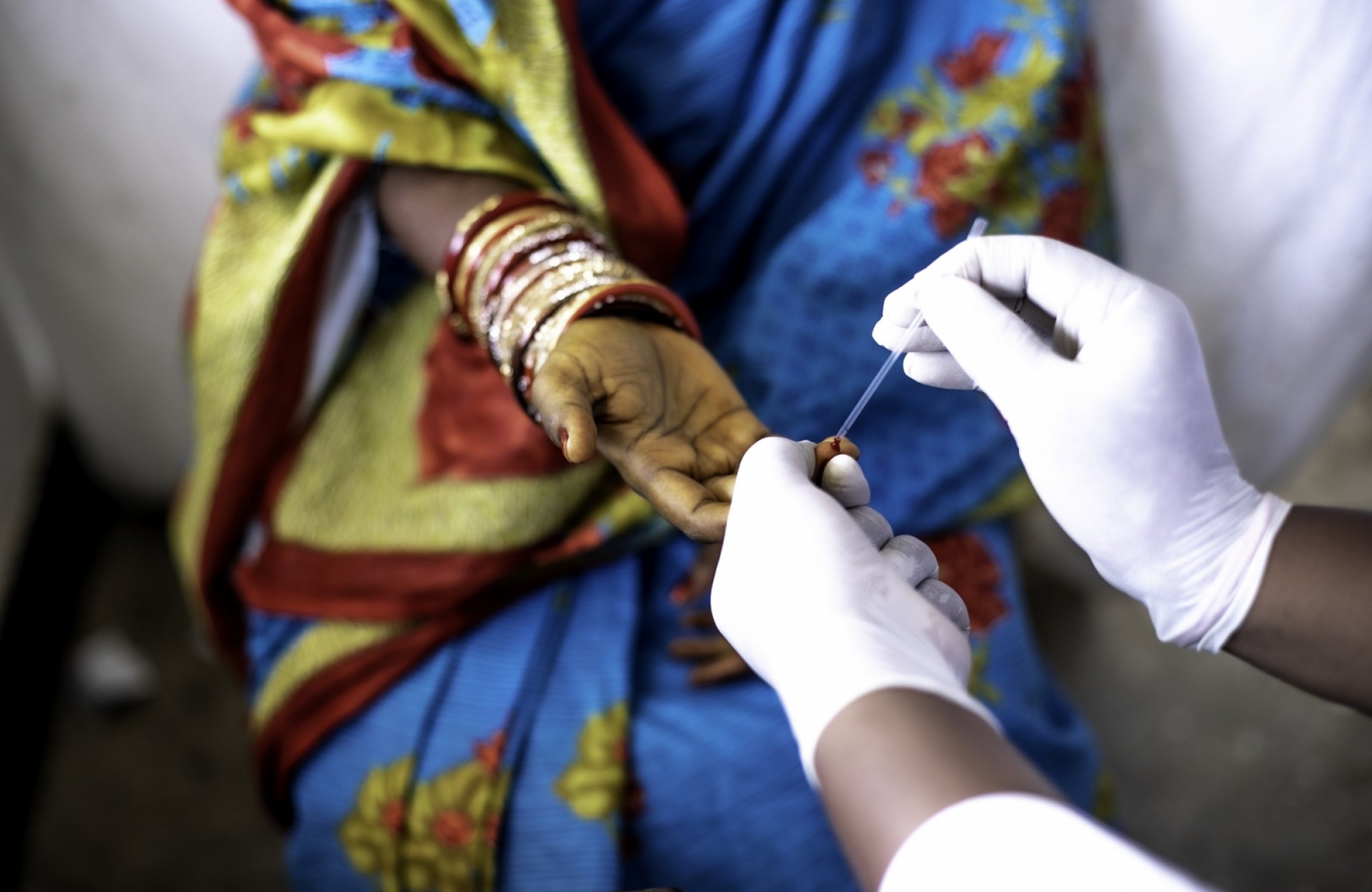 Woman gets a finger prick blood test.