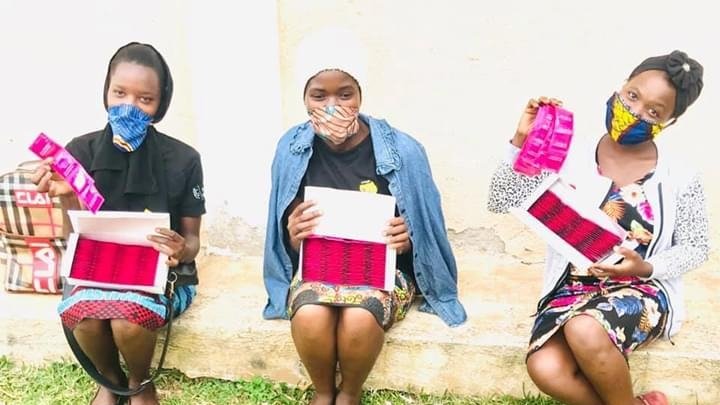 Three young people post with materials from Davision.