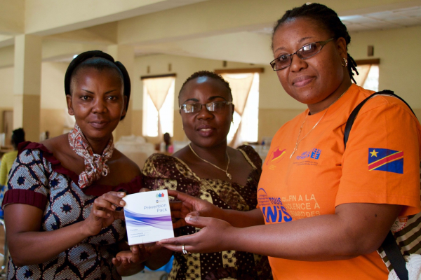 Three members of the Panzi Foundation team pose with award.